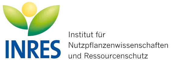 Eine Wissenschaftlerin und ein Wissenschaftler arbeiten hinter einer Glasfassade und mischen Chemikalien mit Großgeräten.